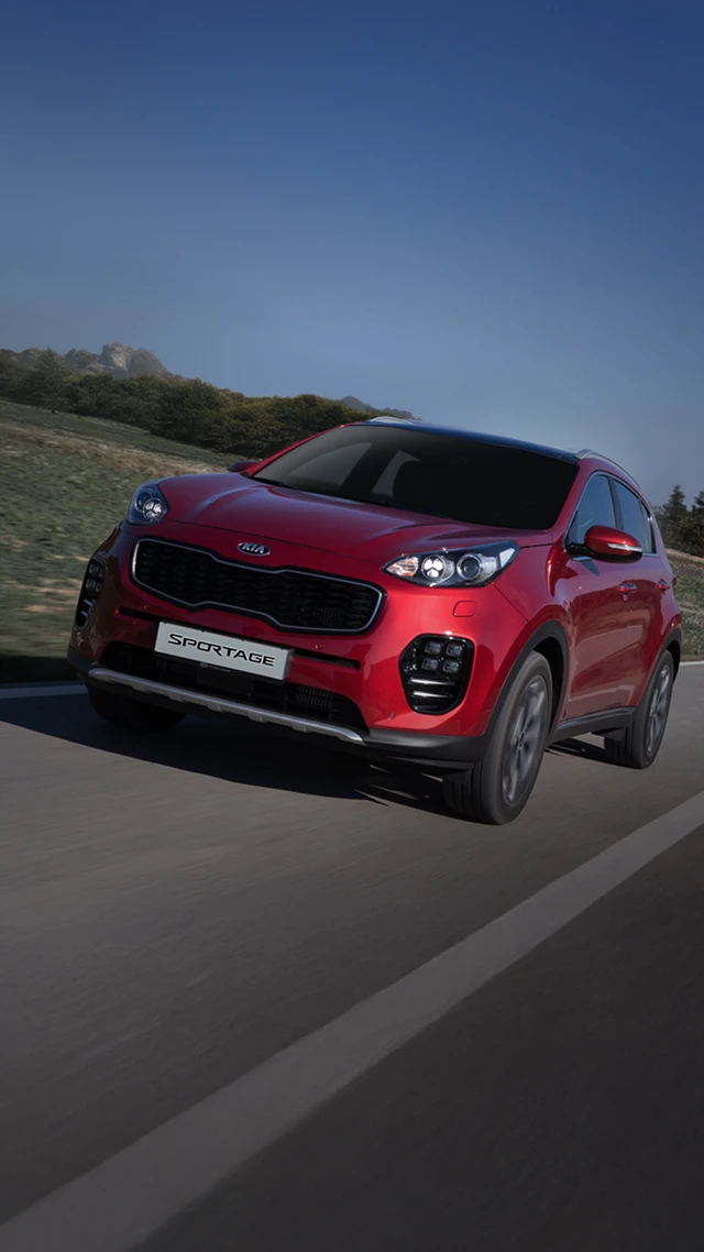 The fourth-generation Kia Sportage driving on a road
