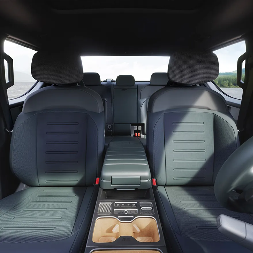 Interior view of the Kia Tasman pickup truck showing the rear seats and center console