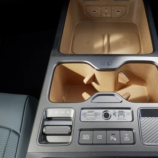 Detailed view of the center console and storage compartments inside the Kia Tasman pickup truck