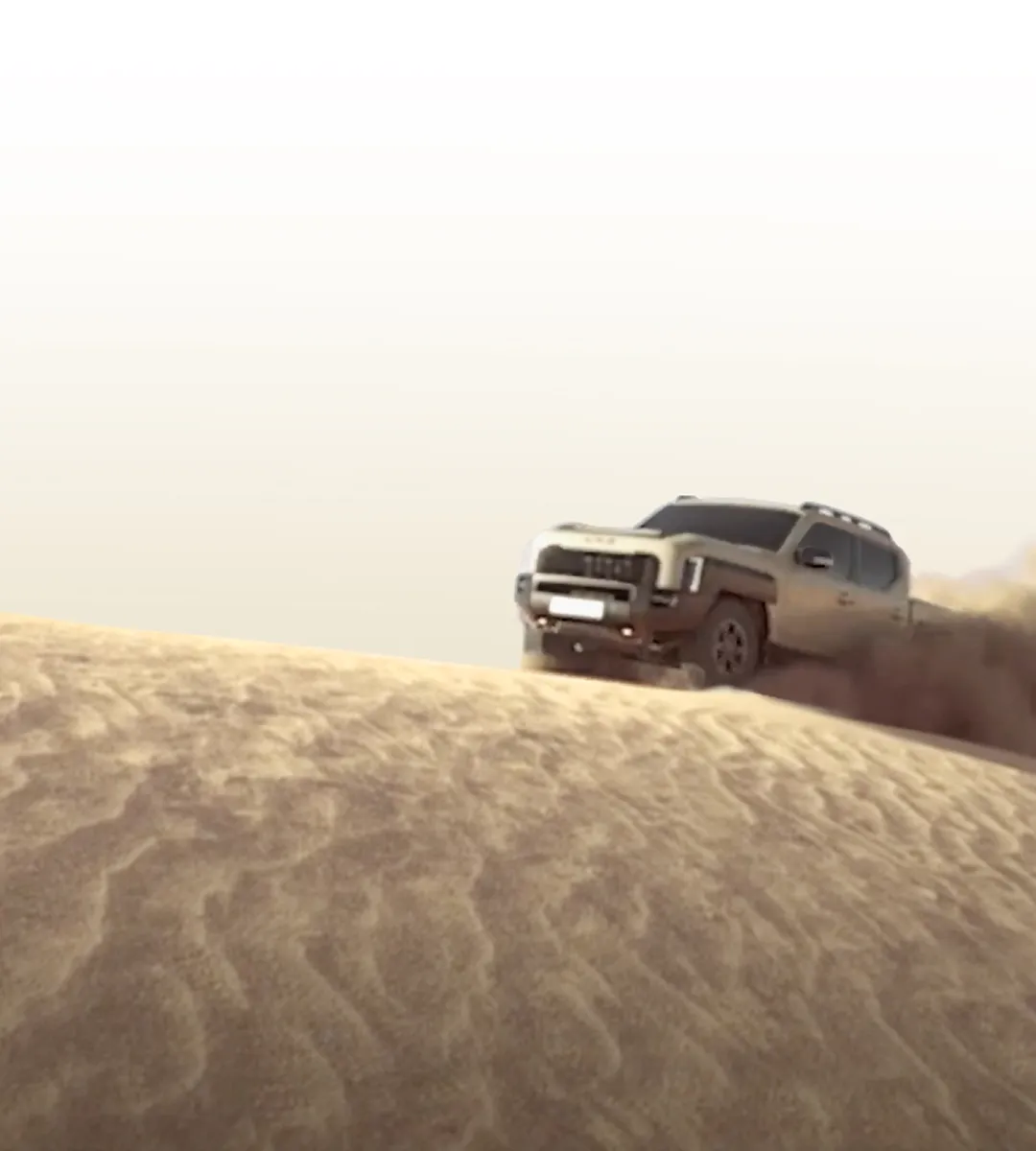 Distant silhouette of the Kia Tasman pickup truck beyond sand dunes