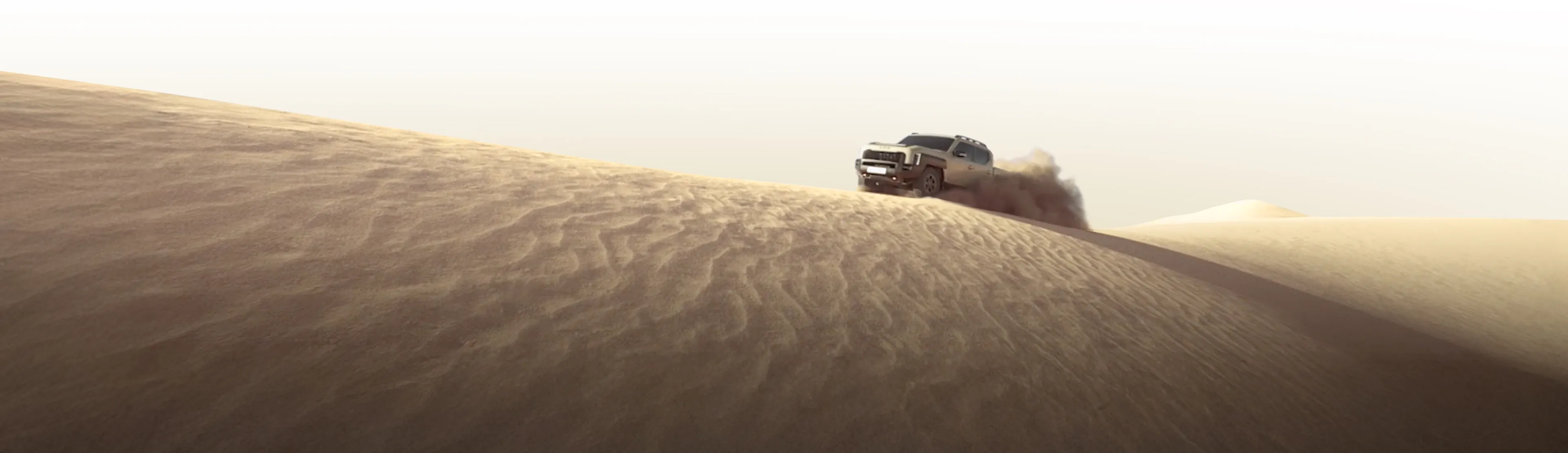 Distant silhouette of the Kia Tasman pickup truck beyond sand dunes