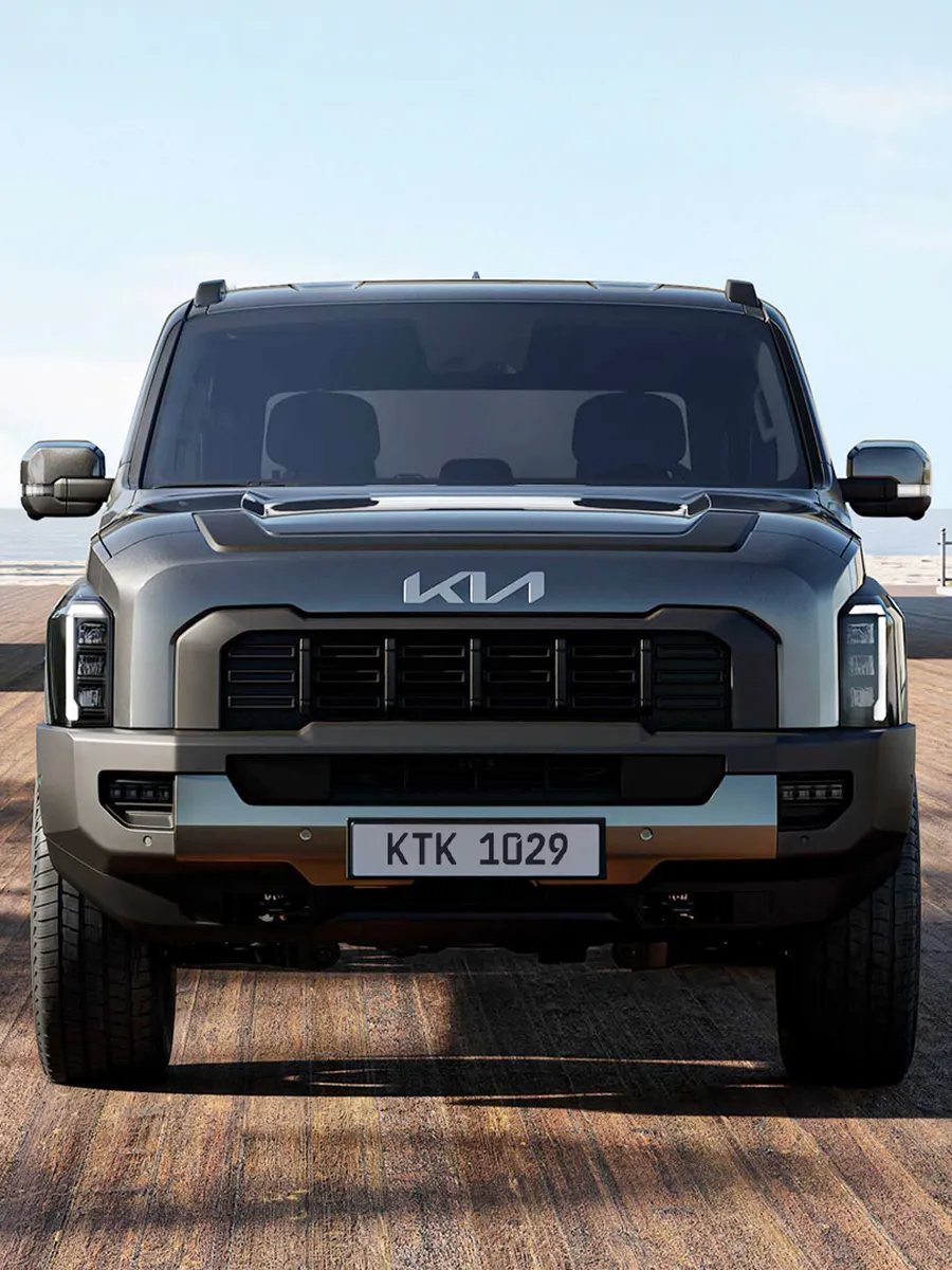 Front view of the Kia Tasman pickup truck set against a desert landscape