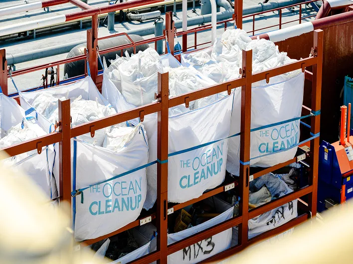 Large bags filled with collected ocean plastic stacked for transport
