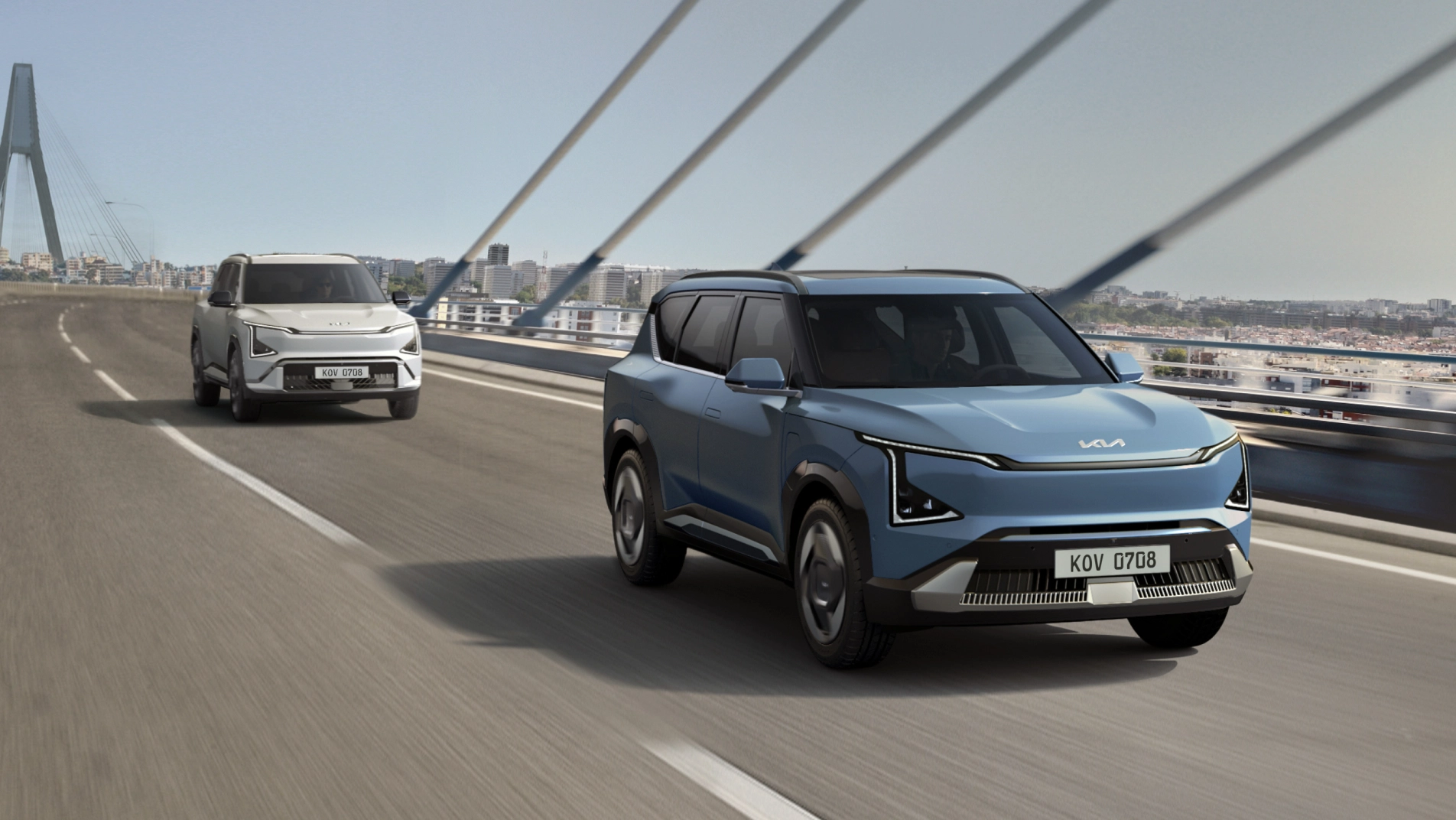 Two EV5 vehicles driving across a bridge.
