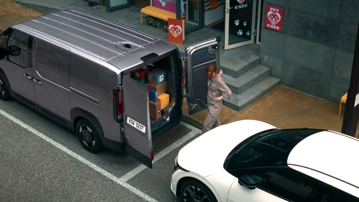 Kia PV5 Cargo parked outside a pet care shop during a delivery